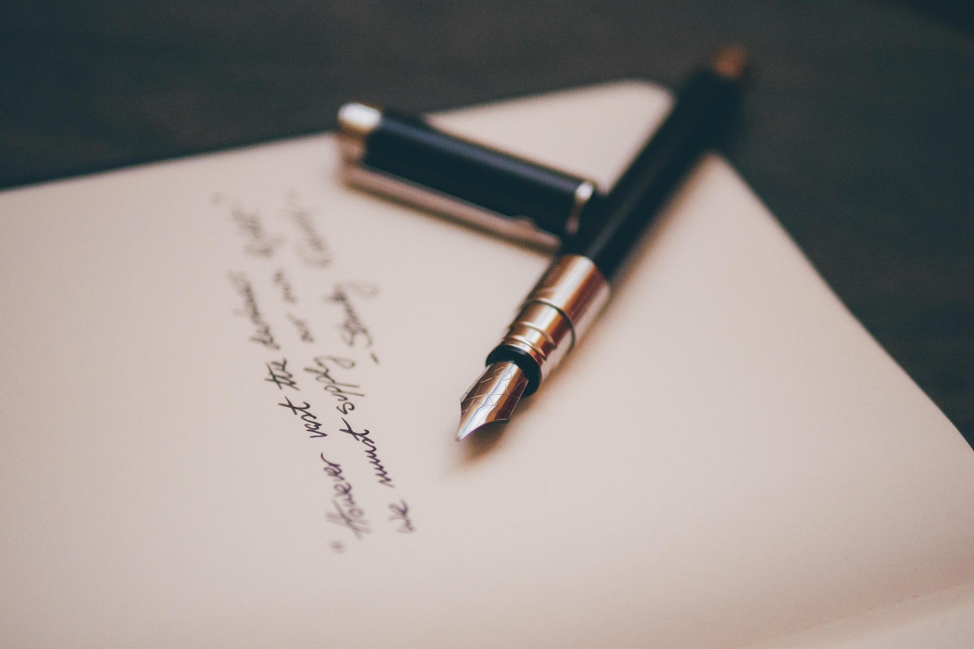 Fountain pen resting on a handwritten letter